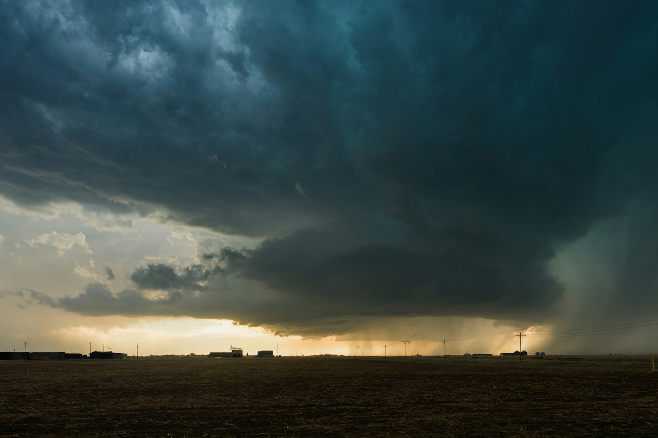Dark storm clouds over an open landscape